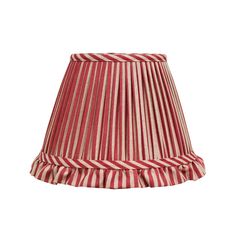 a red and white striped lampshade with pleated trim on the bottom, against a white background