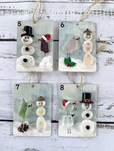 four snowmen are hanging on the wall