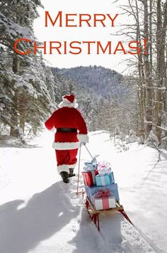 a man in santa suit pulling a sleigh with presents on it through the snow