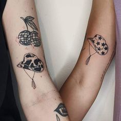 two people with tattoos on their arms holding each other's hands and one has an american flag