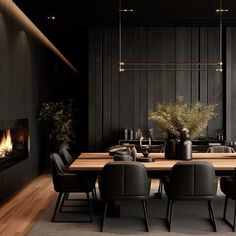 a dining room table with black chairs and a fire place in the wall behind it