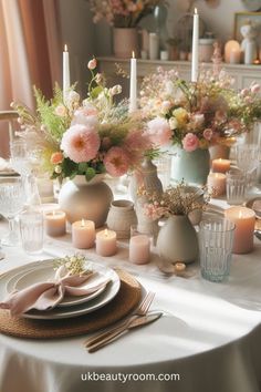 a table set with flowers and candles in vases, plates and utensils