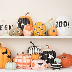 some pumpkins are sitting on shelves with eyes painted on them