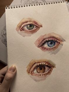 someone is holding up a drawing of their eyes