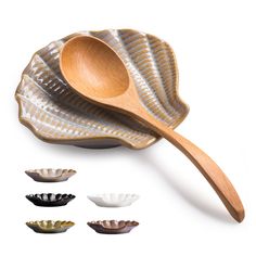 wooden spoons and bowls are lined up on a white surface