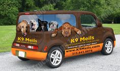 an orange van with dogs on it's side