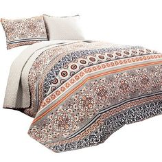 an image of a bed that is made up with paisley print sheets and pillow cases