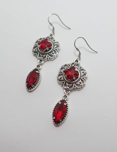 "This is a new handmade pair of earrings. They are made with antiqued silver plated filigrees, accented with high quality RUBY RED glass rhinestones. Earrings measure 2 1/2\" tall, including stainless steel earring hooks, and are 3/4\" wide. Matching necklace and headpiece are available in our store." Ruby Jewelry Silver, Gothic Earrings Victorian, Garnet Earrings Silver, 1920s Earrings, Fantasy Jewellery, Victorian Gothic Jewelry, Victorian Filigree, Red Gothic, Mystery Dinner