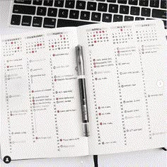 a notebook with a pen on top of it next to a keyboard