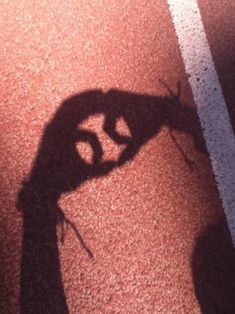 the shadow of a person holding a tennis racquet