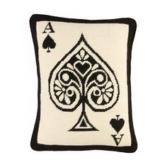 a black and white needleed pillow with playing cards on it