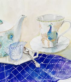 two tea cups and saucers on a table