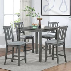 a dining room table with four chairs around it