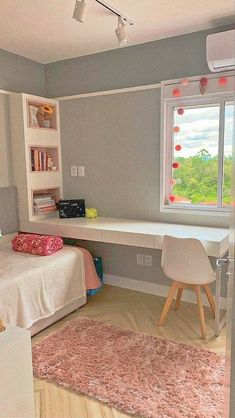 a bedroom with a bed, desk and window