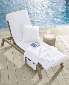 an empty lounge chair next to a swimming pool