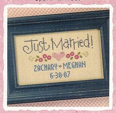 a cross stitched picture frame with the words just married