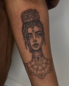 a woman's leg with a tattoo on it that has an image of a woman wearing