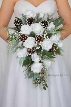 a bridal holding a bouquet of white flowers and pine cones