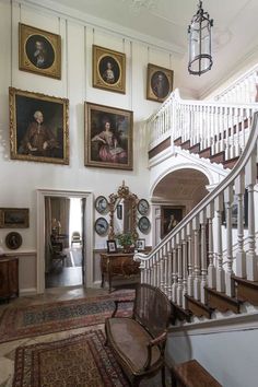 an ornate staircase with paintings on the wall