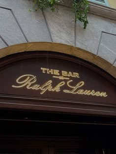 the sign on the building says the bar raff lauson in gold lettering,