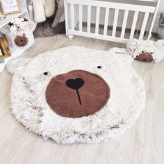 a teddy bear rug in the middle of a room with other stuffed animals on the floor