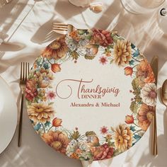 a thanksgiving dinner plate on a table with silverware and flowers in the center that reads, thanksgiving dinner alexandria & michael