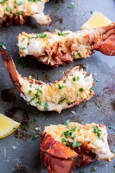 cooked lobsters with lemon wedges and parsley