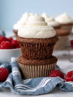 chocolate cupcakes with whipped cream and raspberries