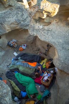 an image of a group of people sleeping in the rocks