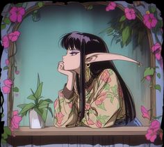 a woman with long black hair sitting at a table in front of flowers and plants