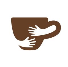 two hands holding each other over a coffee cup