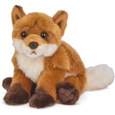 a stuffed fox is sitting on the ground with its eyes open and it's head turned to the side