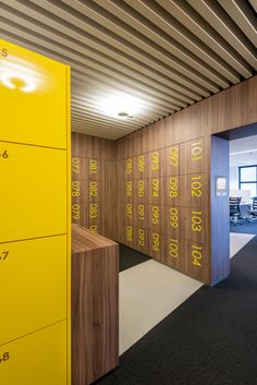 an office building with wooden walls and numbers on the wall, as well as desks