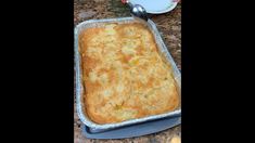 a casserole in a pan with a spoon next to it on a counter