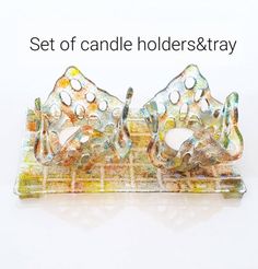 a set of candle holders and trays made out of stained glass, with the words set of candle holders & tray