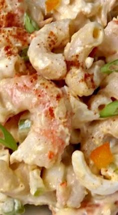 a close up of a plate of food with pasta and vegetables on it, including carrots