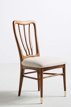 a wooden chair sitting on top of a white floor