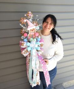 a woman standing next to a wall holding a bunch of candy canes in her hand