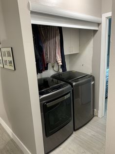 a washer and dryer are in the corner of a room with white walls