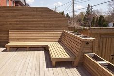 a wooden bench sitting on top of a wooden deck