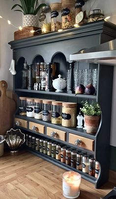 an old dresser is filled with spices and other things to put on it's shelves