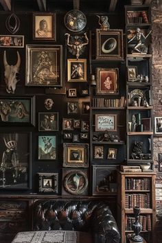 a living room filled with lots of framed pictures on the wall above a leather couch