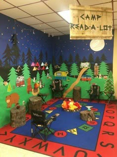 a room decorated with camping themed decorations and trees on the wall, while children's play area is painted in bright colors