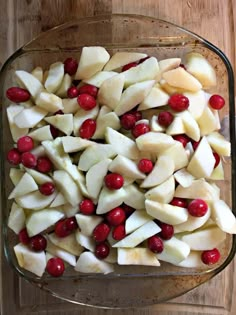 sliced apples and cranberries in a glass dish