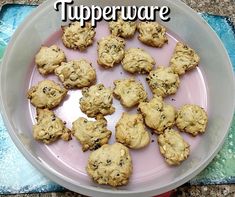 a plate full of cookies sitting on top of a blue and green table cloth with the words tupperware