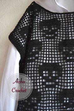 a black crochet sweater hanging on a white wall with the words asia crochet written across it