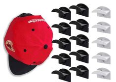 a red and black baseball cap is next to several white caps that are attached to each other