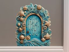 a blue door with shells and seashells on it