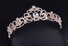 a tiara is shown on a black leather surface, with diamonds in the center