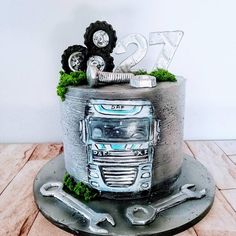 a cake decorated with an old truck and tractor wheels